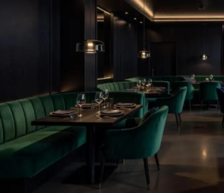Low-lit modern Australian supper hall with velvet seating and espresso black tones